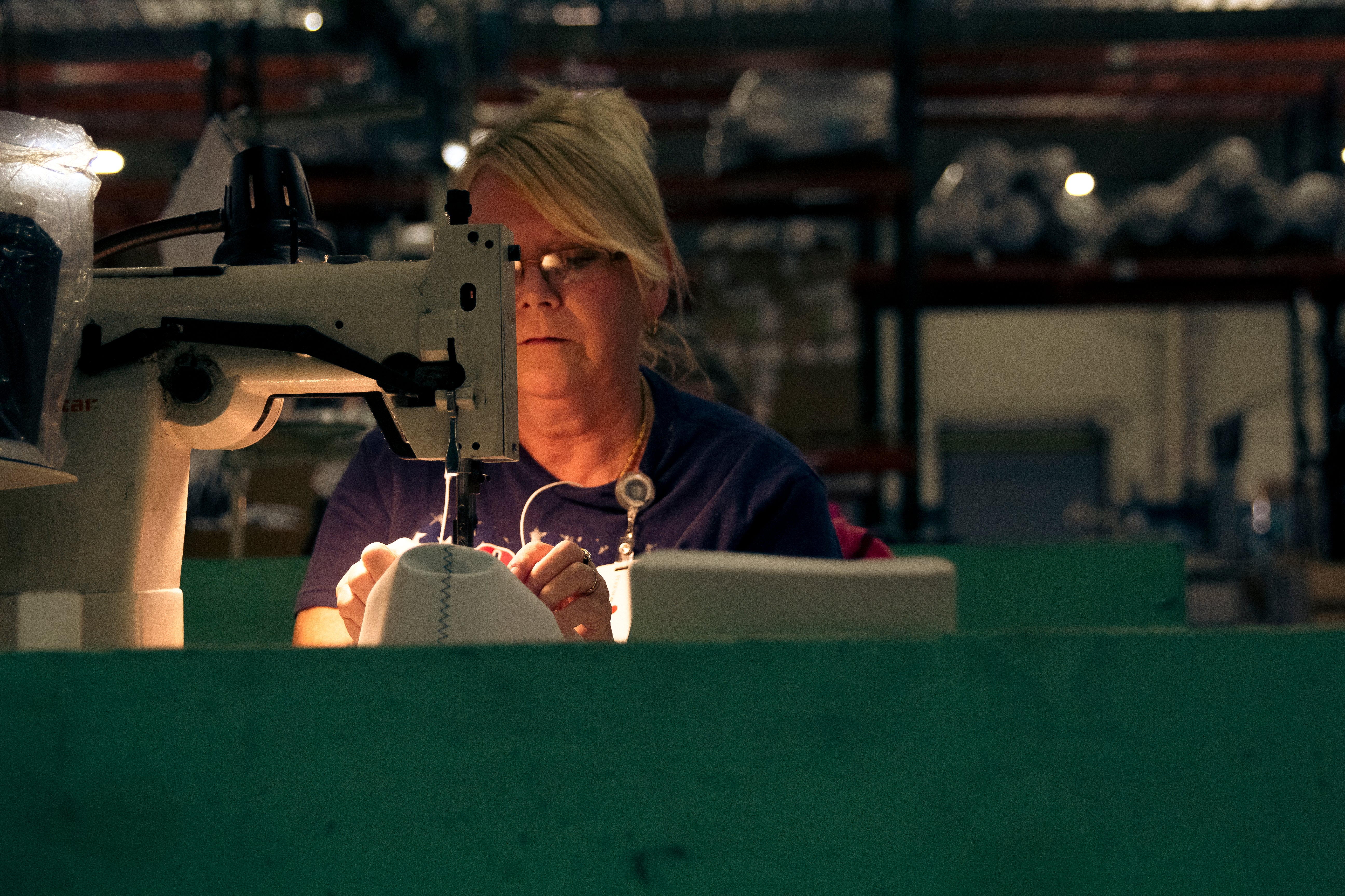 A female factory worker sewing footwear lining  in our Big Rapids, Michigan Manufacturing Facility.