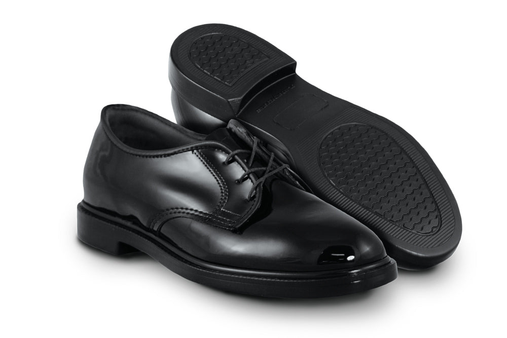 Glossy leather shoes show sole and top at different angles